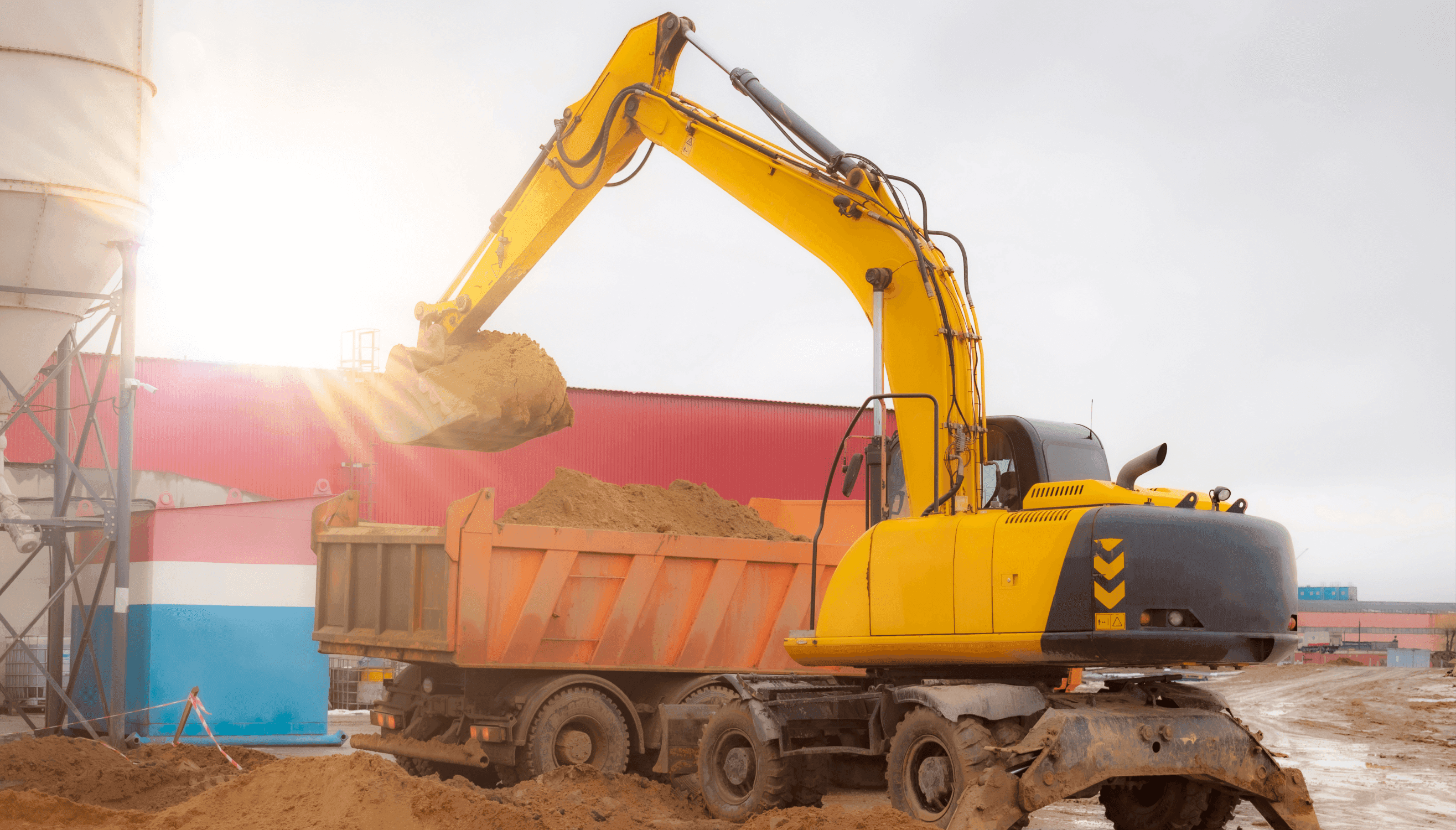 Commercial demolition services in Melbourne, excavator loading debris into a truck at an industrial site - Exccell Demolition